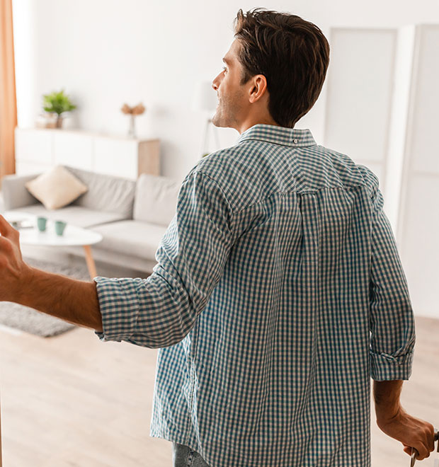 A young man walking through his new home.